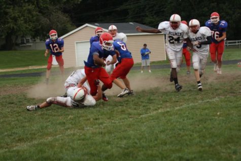 Mason Taylor runs against the Cedar Falls defense during the freshman football game. The Warriors won 21-7.